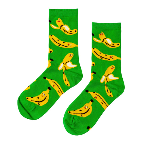 Bright green crew socks featuring playful illustrated banana characters by Kristina Micotti for Yellow Owl Workshop