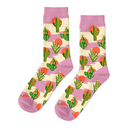 Pink and cream crew socks featuring bold illustrated cacti including saguaro prickly pear and agave with orange desert suns by Yellow Owl Workshop