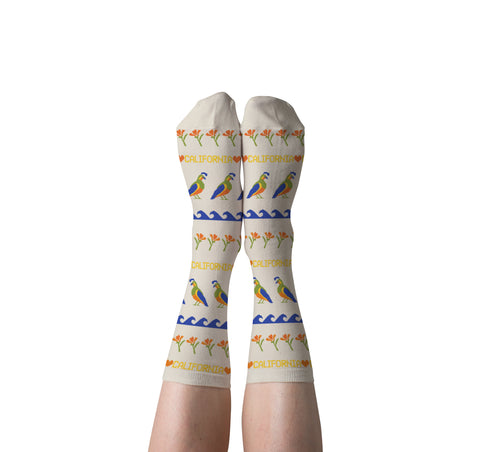 Cream California Quail crew socks with golden poppies and waves worn on feet by Yellow Owl Workshop