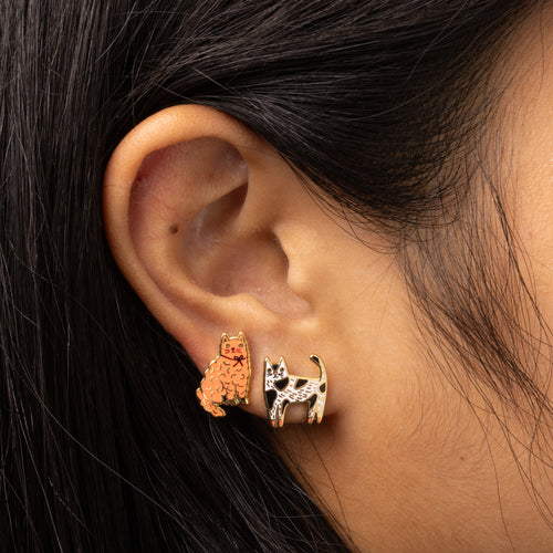 Cat mismatched gold stud earrings worn on ear by Yellow Owl Workshop