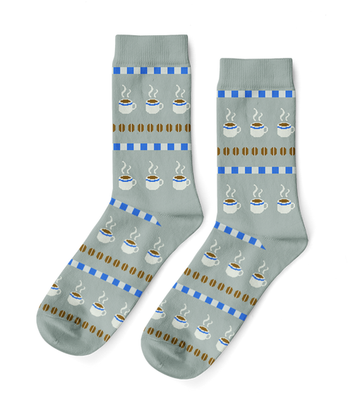 Sage green crew socks featuring illustrated steaming coffee cups and roasted beans in cross-stitch inspired pattern by Yellow Owl Workshop
