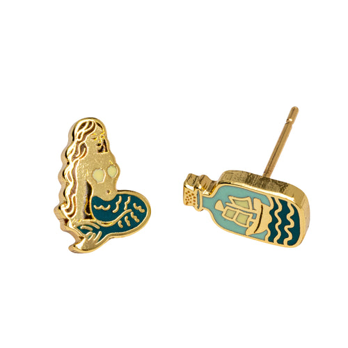 Mismatched mermaid and message in a bottle stud earrings by Yellow Owl Workshop. Gold-tone enamel earrings featuring a mermaid with a teal tail and a turquoise glass bottle with a sailing ship inside. Ocean-inspired jewelry for mermaid lovers and nautical accessory fans.