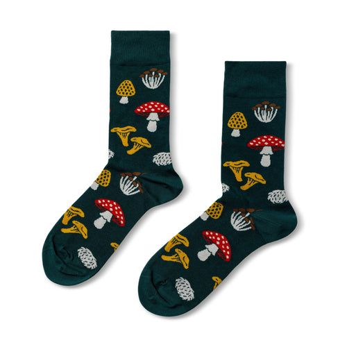Dark green crew socks featuring illustrated forest mushrooms including amanita chanterelle and hen of the woods by Yellow Owl Workshop