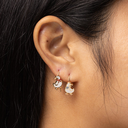 Goose mismatched enamel drop earrings worn on ear by Yellow Owl Workshop
