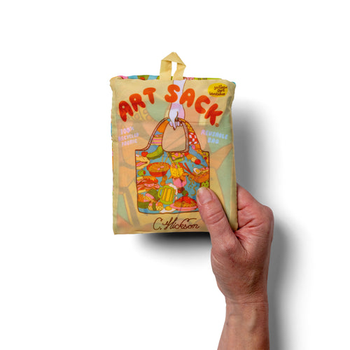Person holding illustrated foodie tote bag with bold 1970s style street food print by Clay Hickson for Yellow Owl Workshop