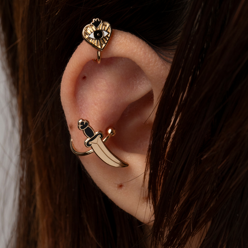 Gold heart and dagger no-piercing ear cuffs worn on ear by Yellow Owl Workshop
