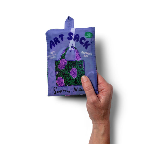 Person holding illustrated botanical tote bag with painted lilac print by Sophy Naess for Yellow Owl Workshop
