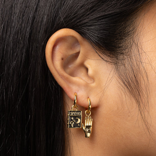 Mystic Spells cloisonné gold hoop earrings worn on ear by Yellow Owl Workshop