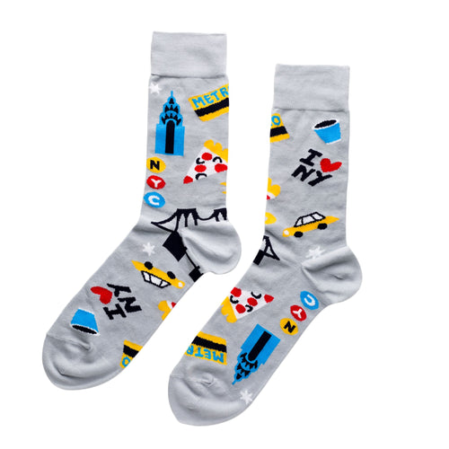 Grey crew socks featuring illustrated New York City icons including Chrysler Building yellow cab pizza slice subway token and I Love NY by Yellow Owl Workshop