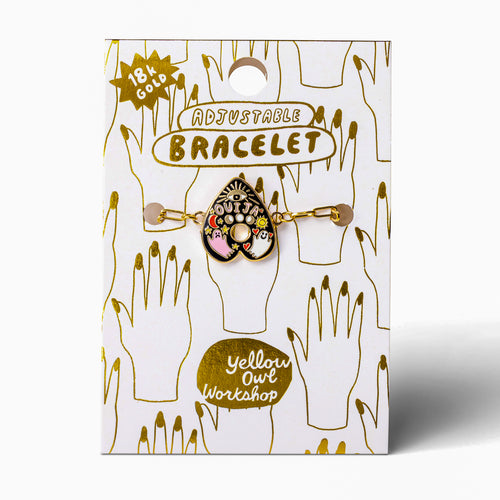 Black enamel Ouija charm bracelet on gold foil packaging card by Yellow Owl Workshop