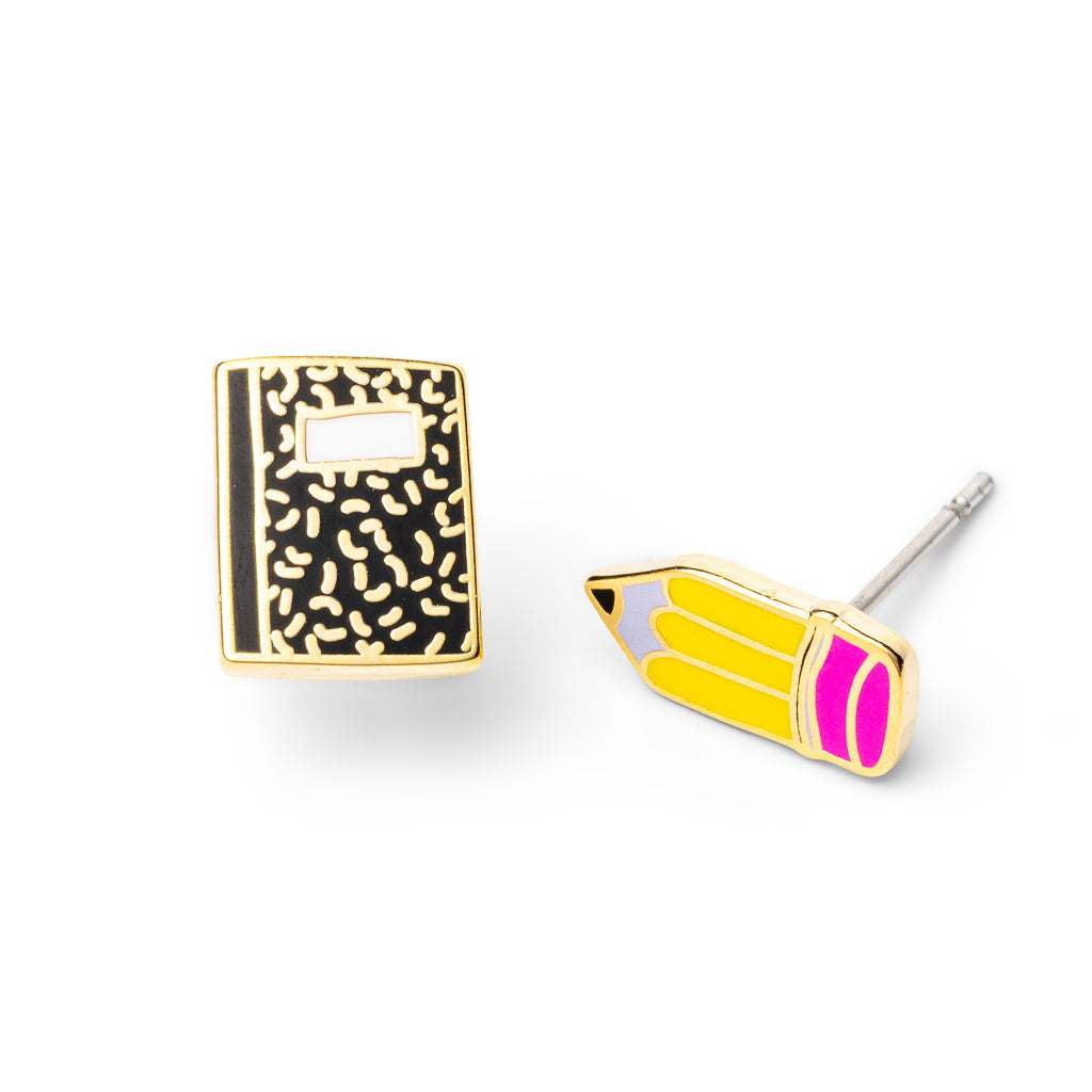 Mismatched gold stud earrings featuring black composition notebook and yellow pencil with pink eraser by Yellow Owl Workshop
