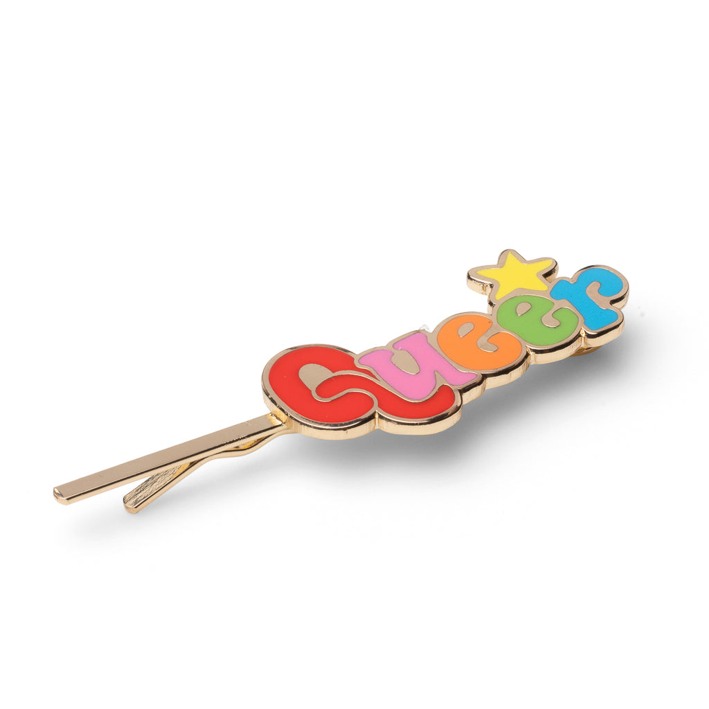 Gold cloisonné enamel hair pin spelling Queer in rainbow bubble letters with gold star by Yellow Owl Workshop