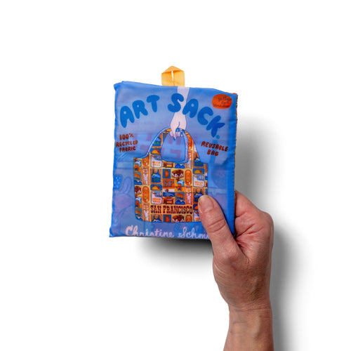 Person holding illustrated San Francisco tote bag with colorful SF landmark and icon print by Yellow Owl Workshop
