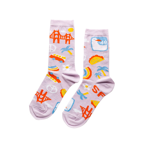 Lavender crew socks featuring San Francisco icons including Golden Gate Bridge VW bus peace sign taco and SF text by Yellow Owl Workshop