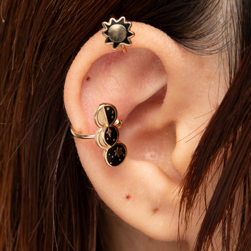 Gold sun and moon phases no-piercing ear cuffs worn on ear by Yellow Owl Workshop