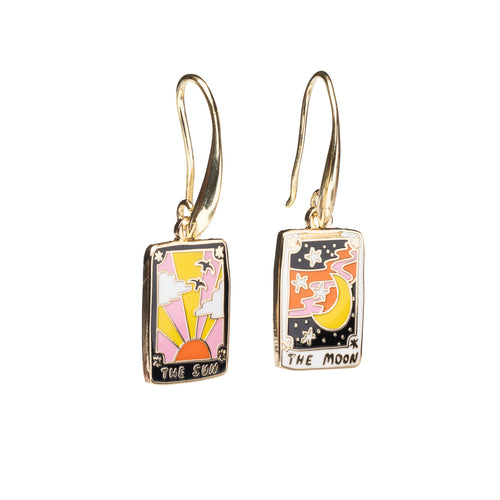 Mismatched enamel drop earrings featuring The Sun tarot card with sunrise and birds and The Moon tarot card with crescent moon and stars by Yellow Owl Workshop