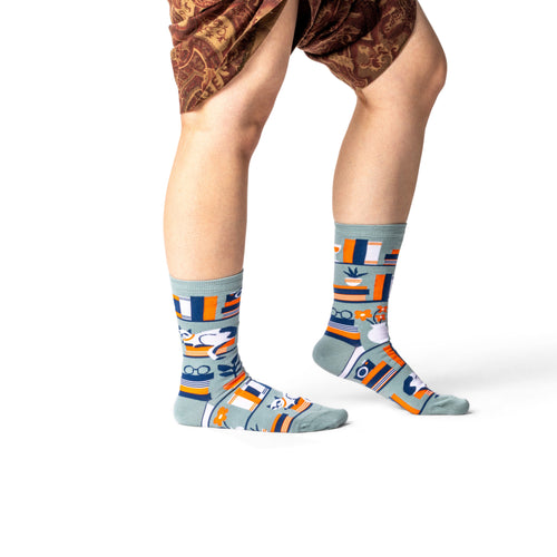Person wearing patterned socks on a white background