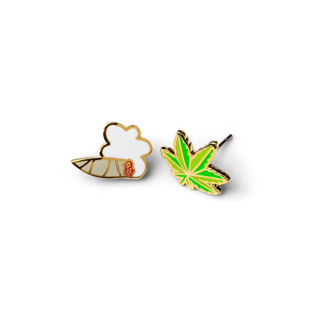 Mismatched gold stud earrings featuring lit joint with smoke cloud and bright green cannabis leaf by Yellow Owl Workshop