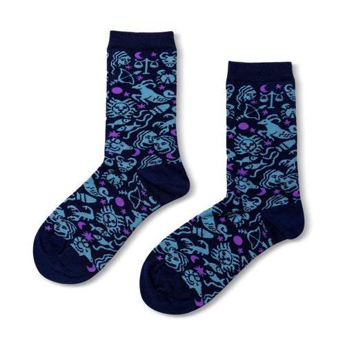 Navy crew socks featuring all twelve illustrated zodiac signs in blue and purple by Yellow Owl Workshop