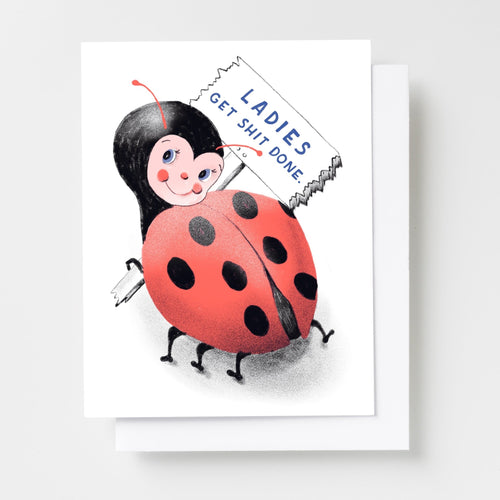 Risograph greeting card with an illustrated ladybug holding a protest sign reading Ladies Get Shit Done on a white background