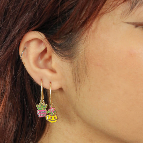 Plant Babe mismatched enamel drop earrings worn on ear by Yellow Owl Workshop