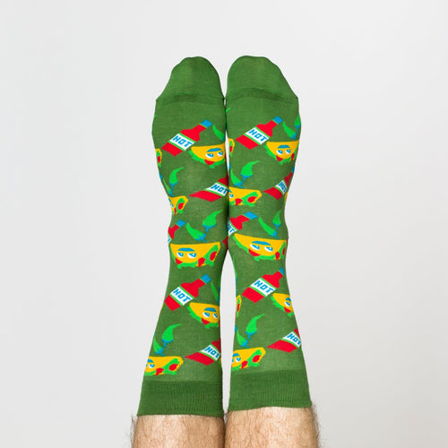 Green Taco crew socks with smiling taco and hot sauce print worn on feet by Yellow Owl Workshop