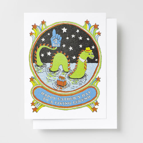 Risograph greeting card with an illustrated Loch Ness Monster wearing a yellow hat and striped tie holding a six-pack and a number one Dad foam finger in a starry circular frame, text reads Happy Father's Day to a Living Legend on a blue banner